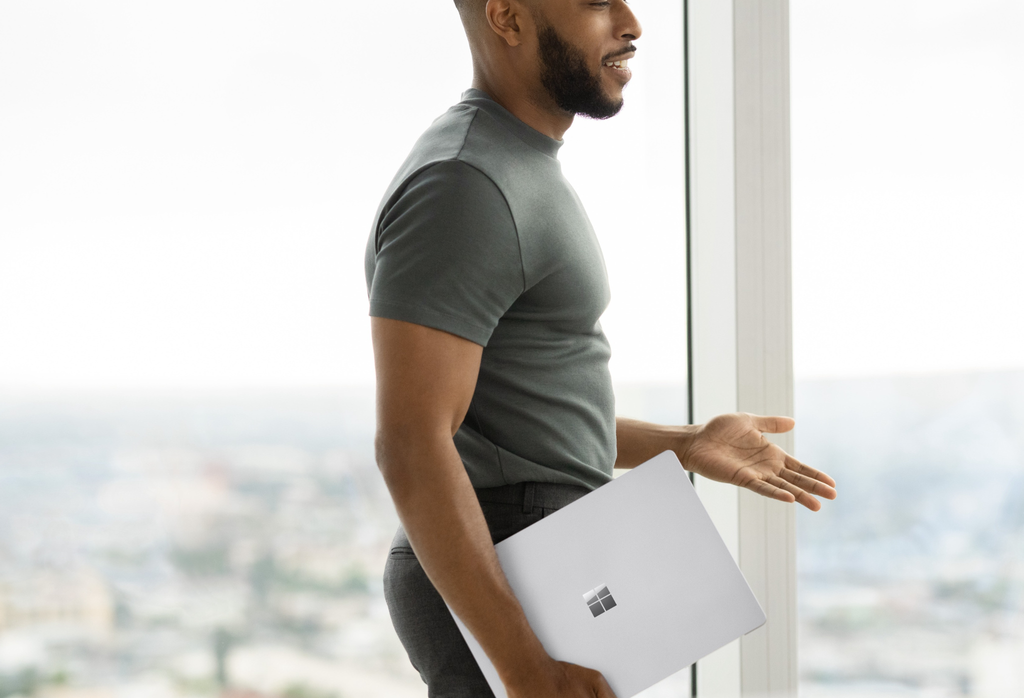 Happy man holding a portable Surface device