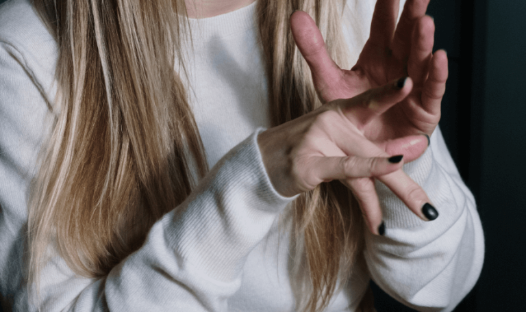 Woman speaking using sign language.